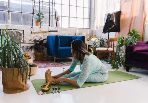 Practicing yoga at home in Yogaste apparel in a studio loft